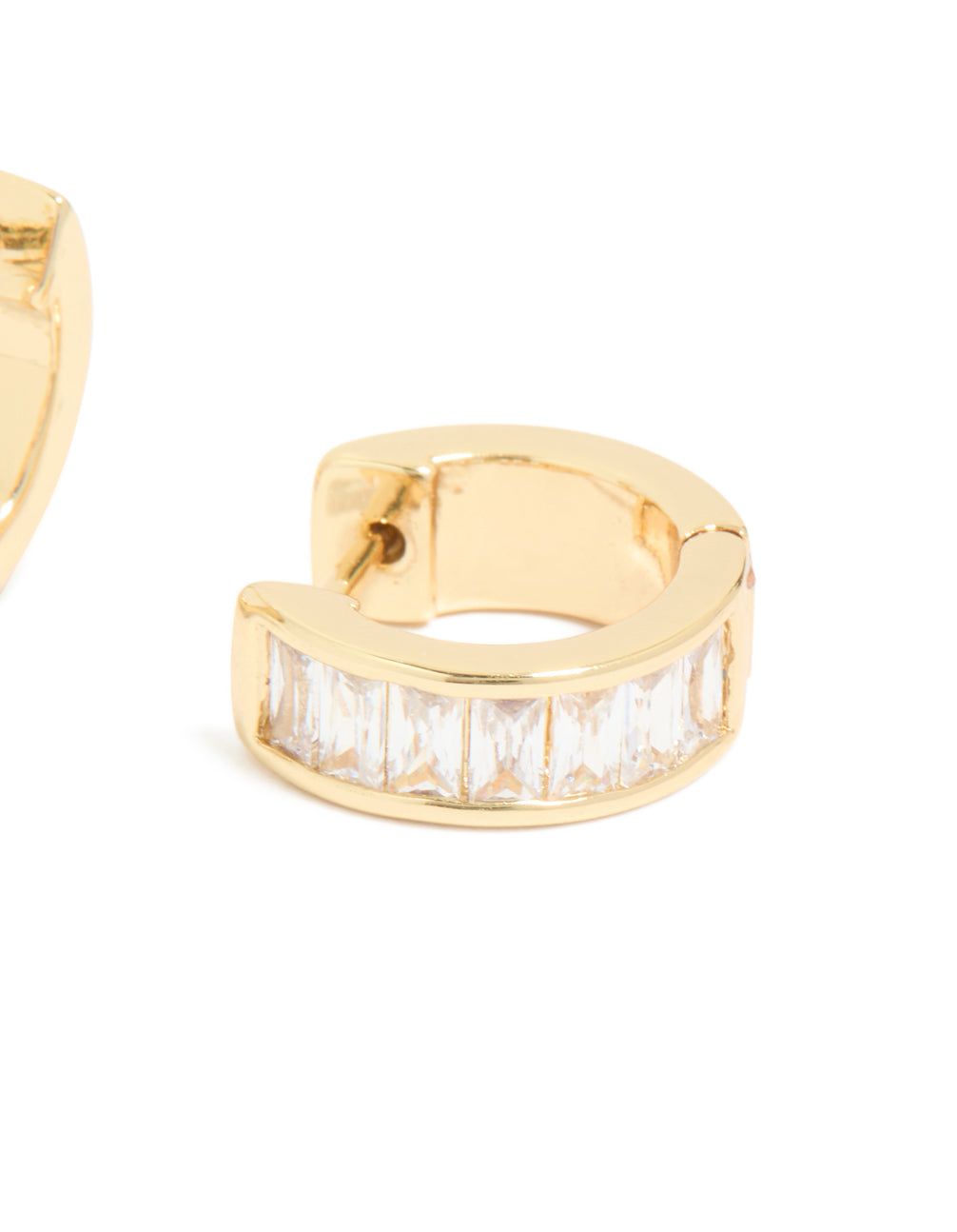 Displaying gold plated cubic zirconia inlay huggie earrings with white baguette stones and closure detail view