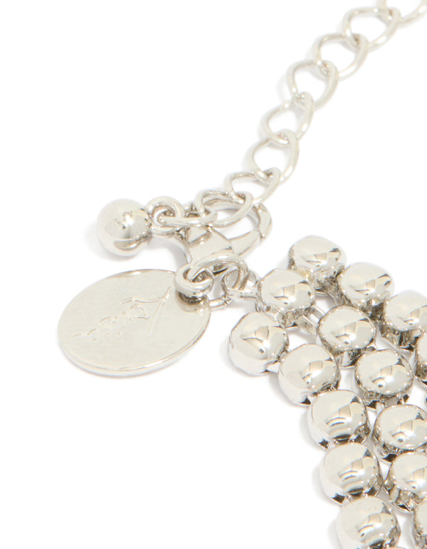 Crafted with silver cubic zirconia half cup chain layered bracelet closure detail view