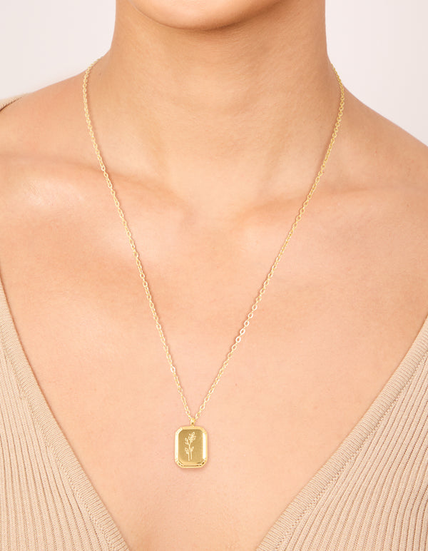 Explore this waterproof December birth flower poinsettia necklace with a floral detail in gold plated stainless steel on neck view