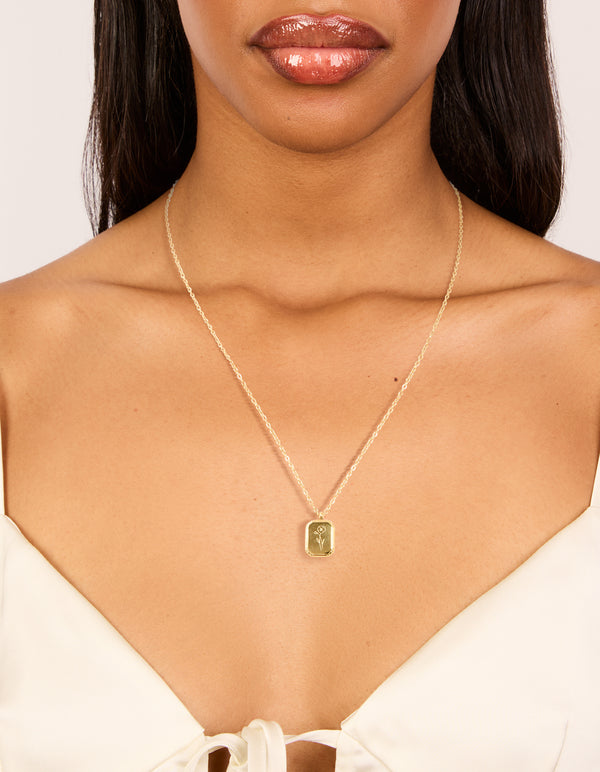 Featuring a waterproof gold plated stainless steel floral detail dainty February birth flower violet necklace on neck view