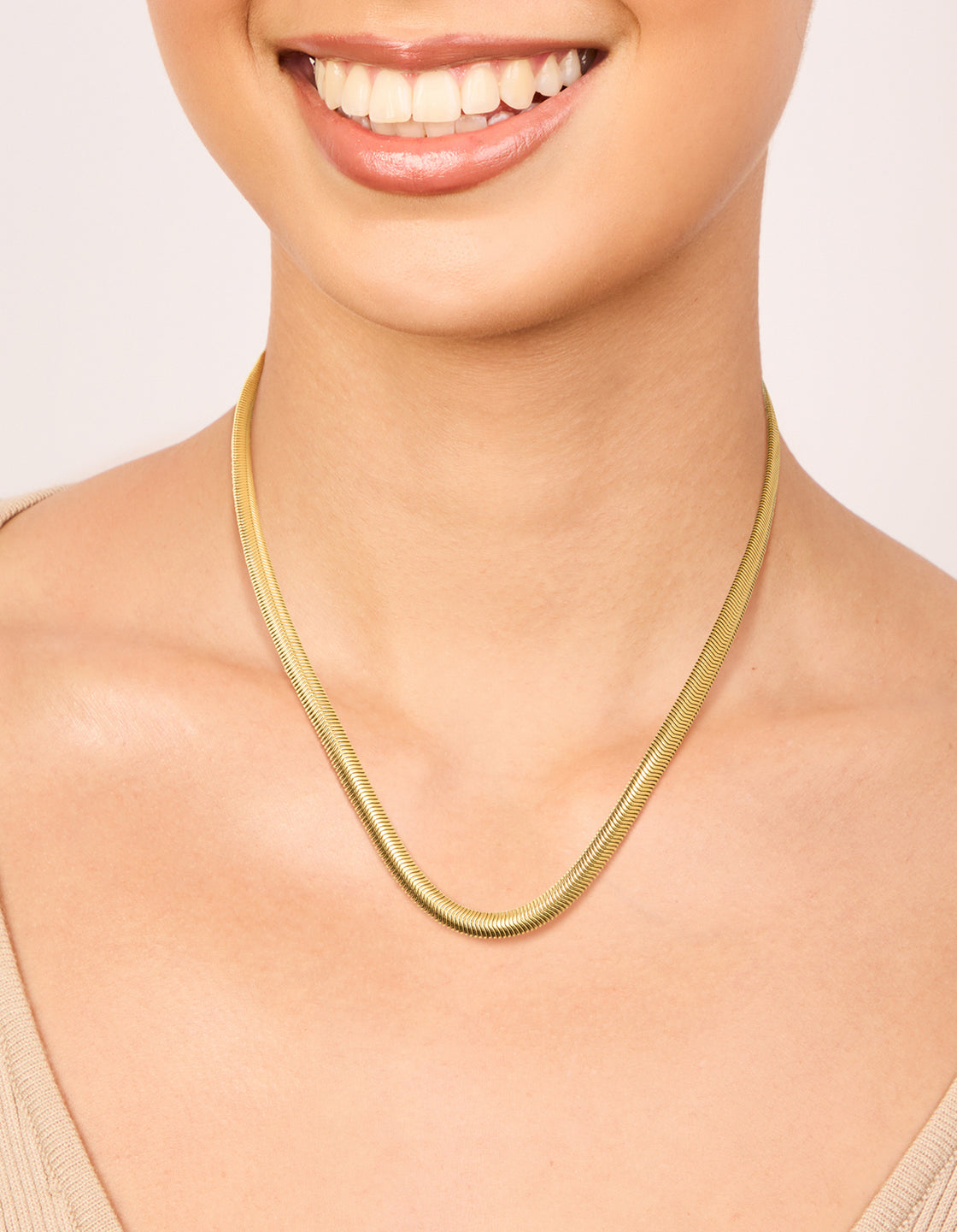 Showcasing a waterproof gold plated stainless steel thick snake chain necklace with statement design on neck view