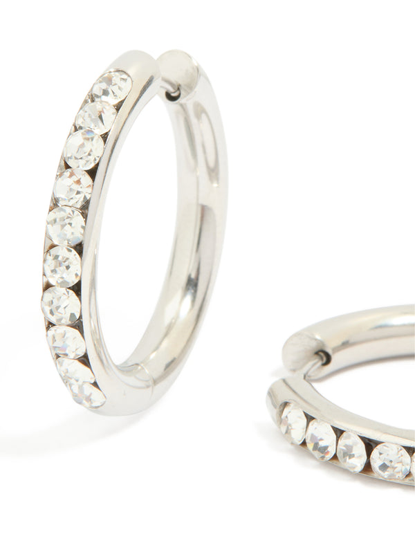 Highlighting waterproof stainless steel half diamante hinge hoop earrings in silver and clear stone close up view