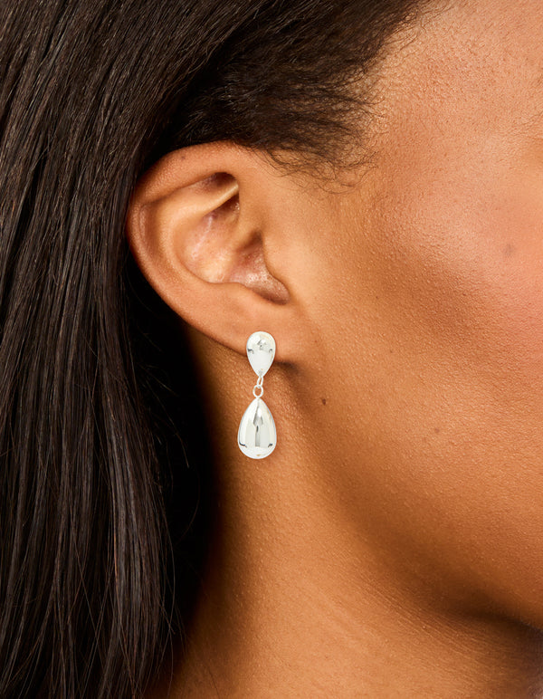 Showcasing waterproof stainless steel pear double drop earrings in silver on ear view