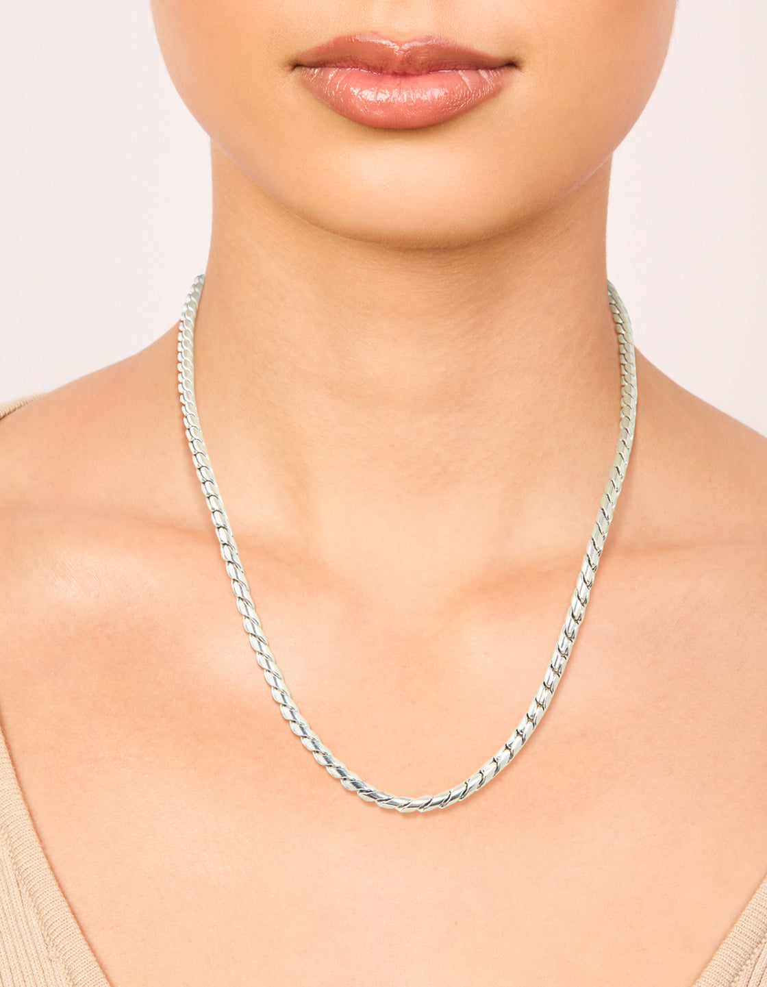 Showcasing a waterproof stainless steel thick twist chain in silver, chunky style on neck view