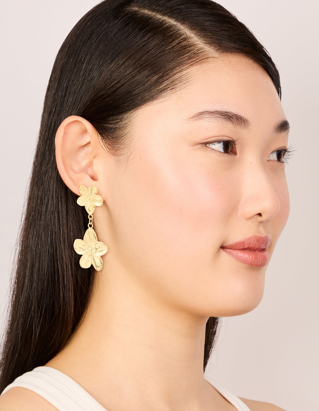 Showcasing waterproof gold plated stainless steel flower drop earrings on model view