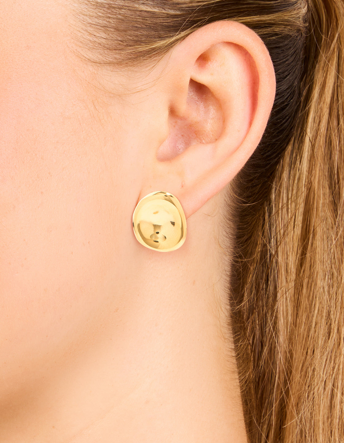 Featuring waterproof gold plated stainless steel button stud earrings in gold with stud closure on ear view