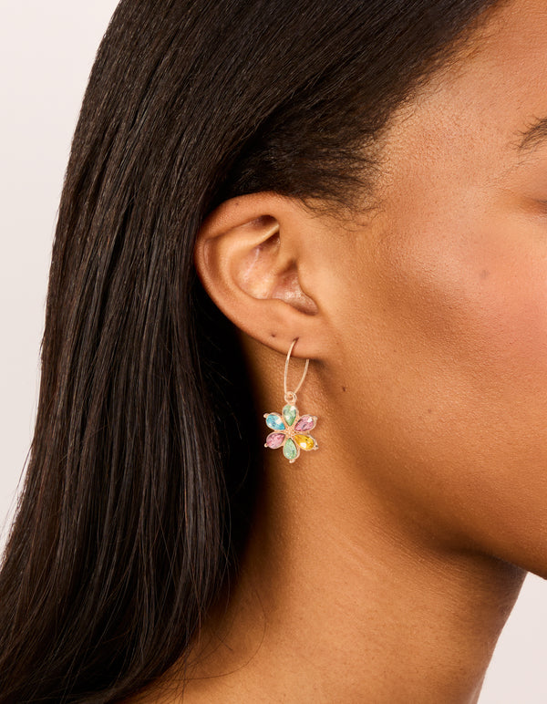 Showcasing gold multicoloured diamante flower huggie earrings with pink, yellow, and aqua accents in huggie closure on ear view