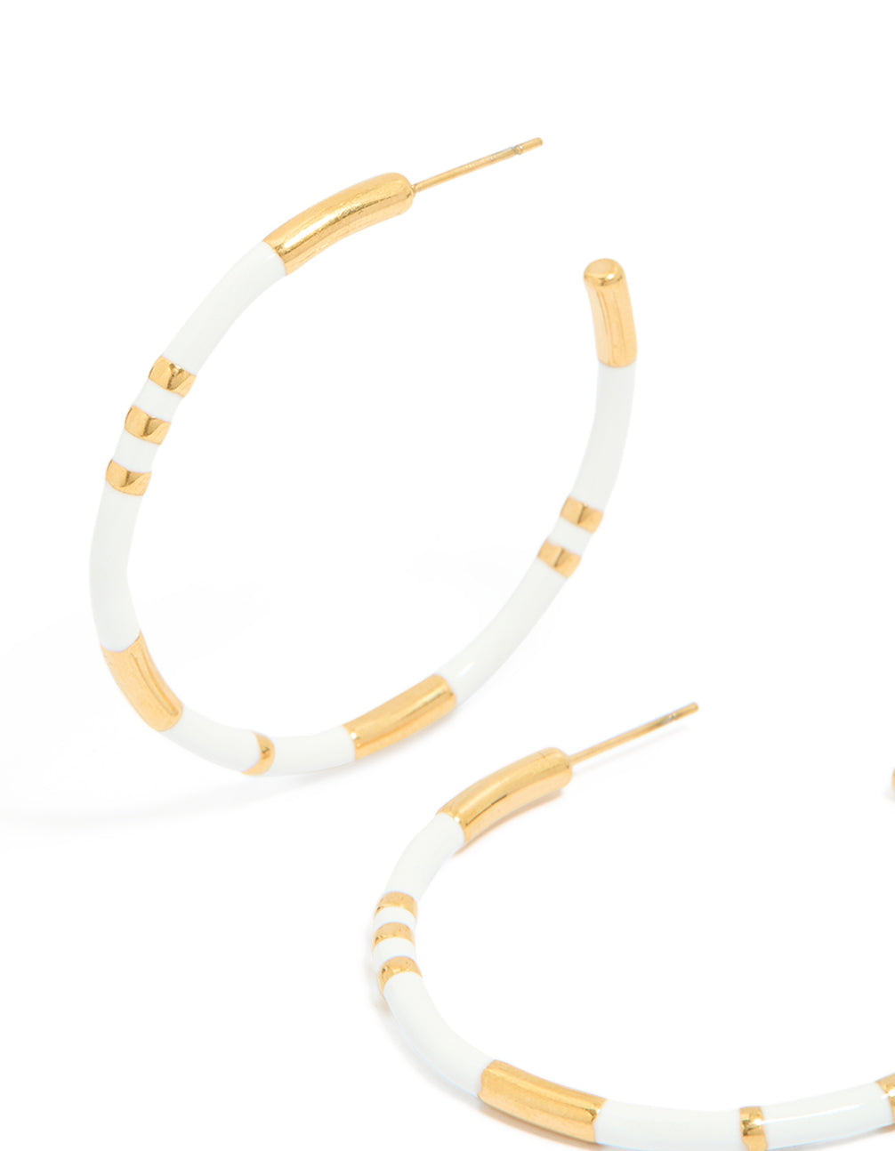 Displaying waterproof statement hoop earrings crafted from gold plated stainless steel with white enamel detailing close up view