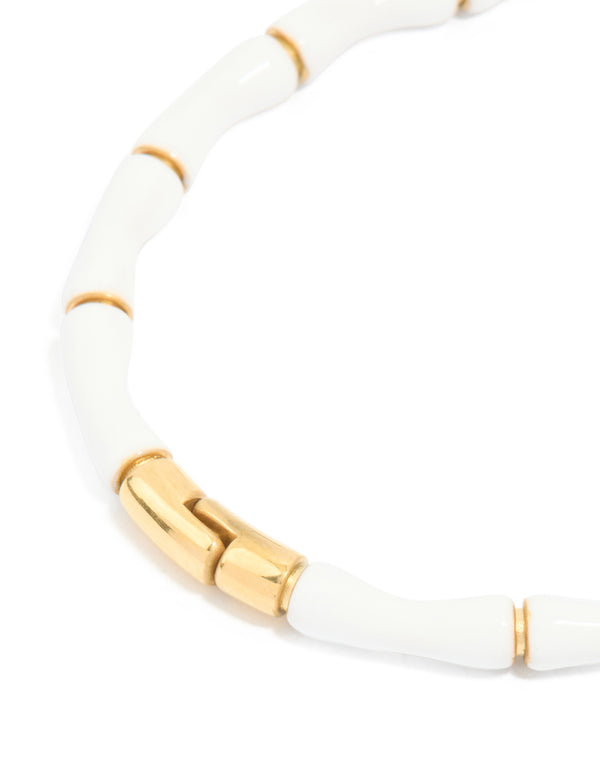Explore a waterproof bamboo bangle crafted from gold plated stainless steel with white enamel closure detail view