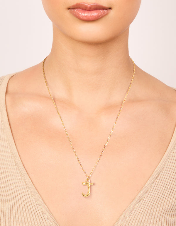 Displayed on neck is a waterproof letter J necklace with initial pendant in bamboo style, gold plated stainless steel on neck view