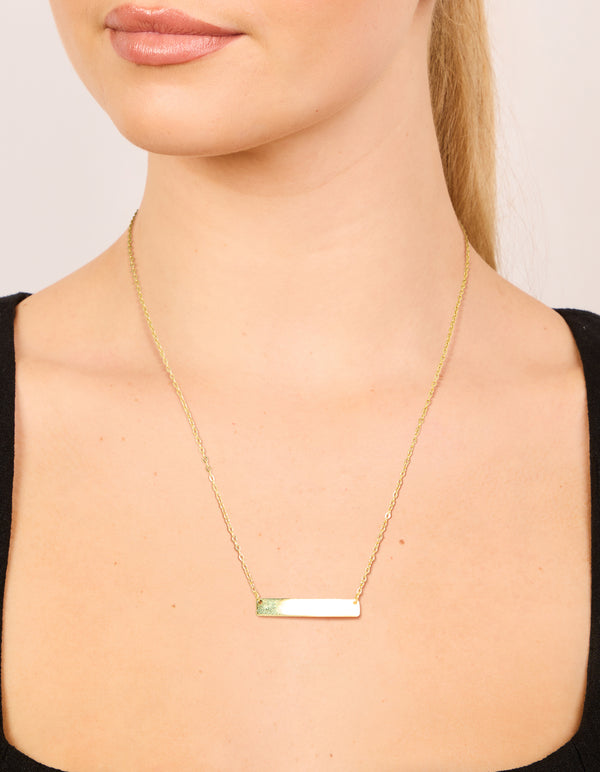 Dainty bar necklace featuring waterproof gold plated stainless steel with cubic zirconia pendant on neck view