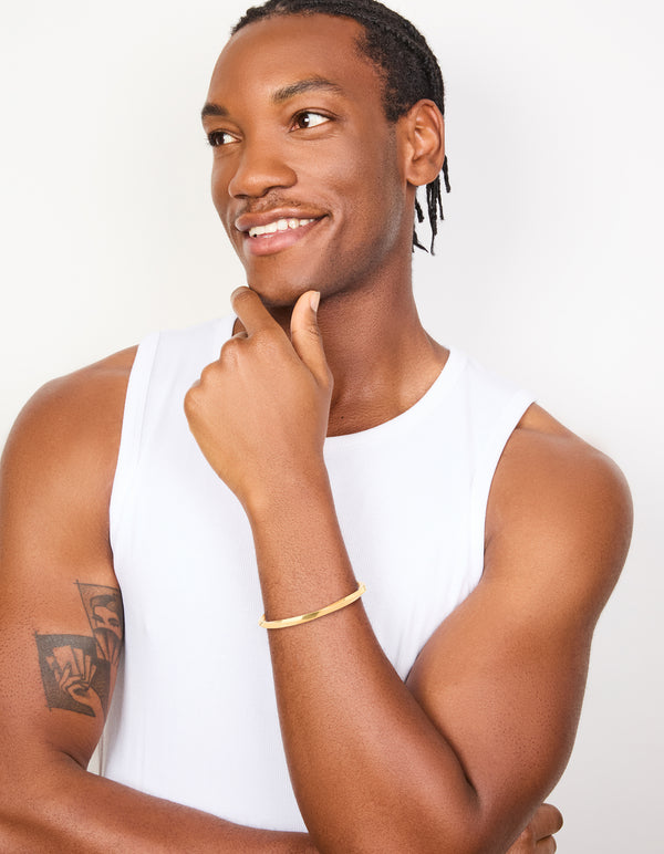 Crafted from waterproof gold plated stainless steel square twist wrist cuff on model view