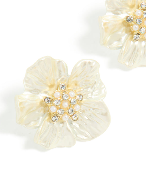 Highlighting statement flower earrings in gold plated finish with pearl and diamante embellished center close up view