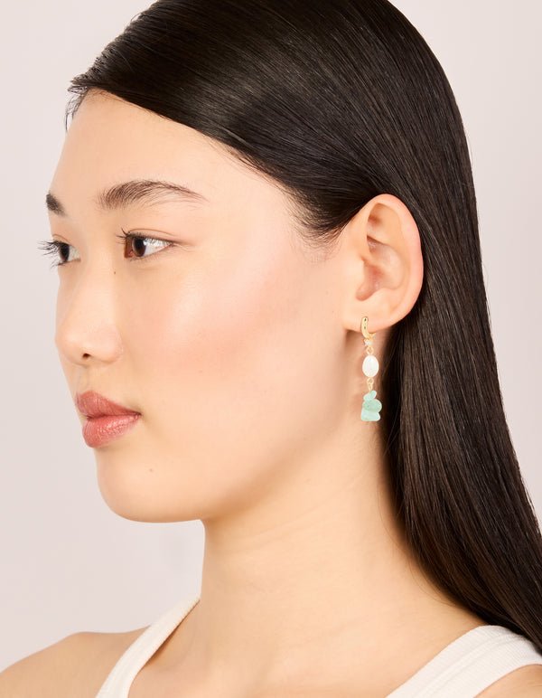 Styled view of statement drop earrings with jade, freshwater pearl and cubic zirconia in gold on model view