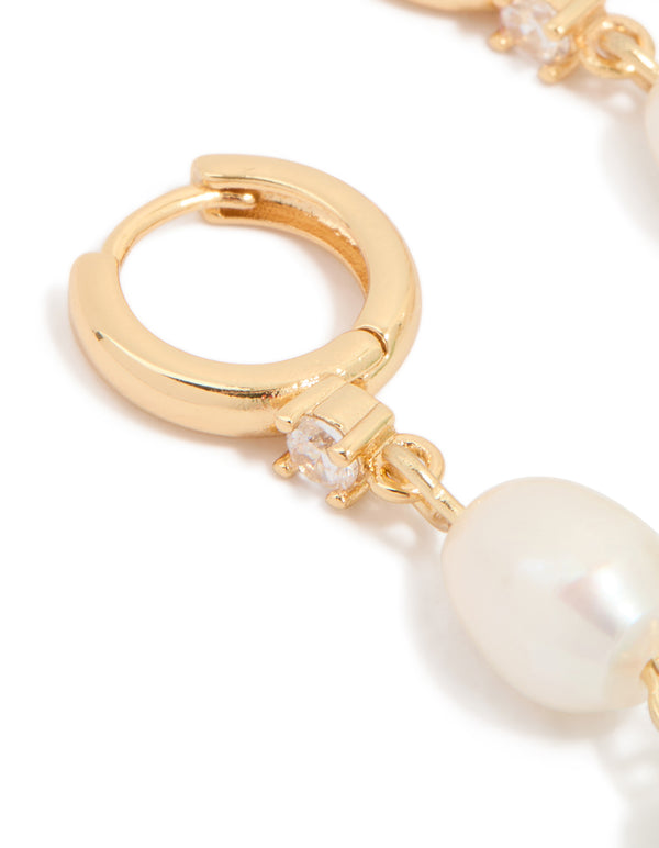 Detailed view of gold drop earring with cubic zirconia stud and freshwater pearl featuring jade close up view
