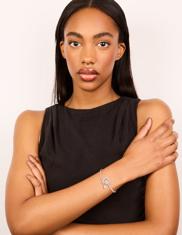 Showcasing a silver cubic zirconia open circle wrist cuff bracelet on model view