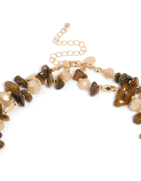 This eclectic acrylic beaded and tigers eye semi precious stone boho layered necklace in brown, peachpuff, and gold clasp detail view