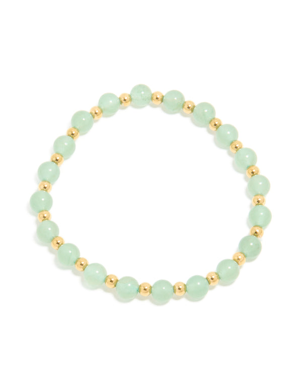 Showcasing a waterproof beaded stretch bracelet crafted from gold plated stainless steel with pale green beads front view