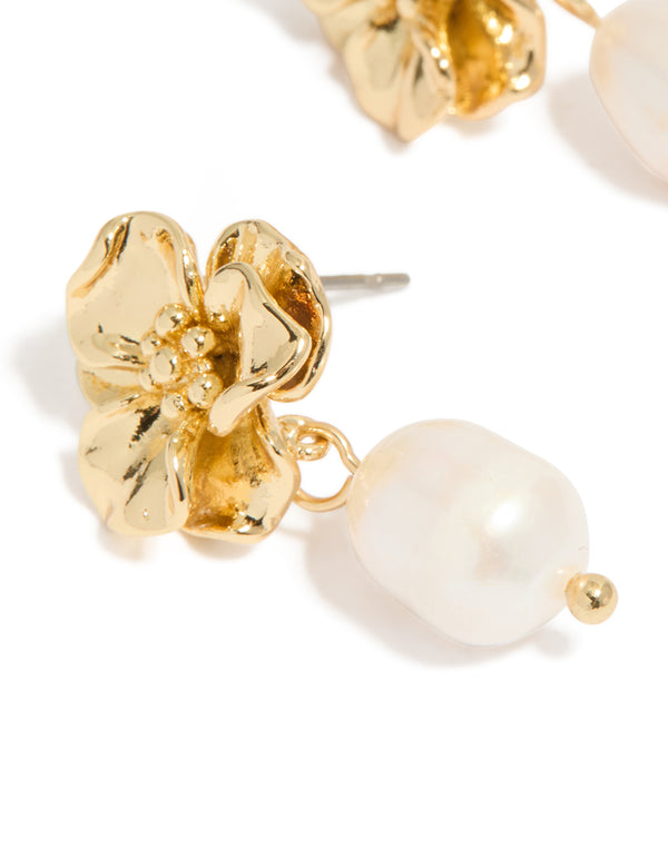 Sophisticated gold plated freshwater pearl flower drop earrings featuring floral design with statement ivory details close up view