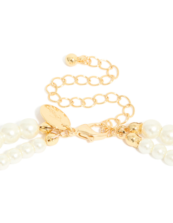 This gold plated cubic zirconia and pearl drop layered necklace clasp detail view