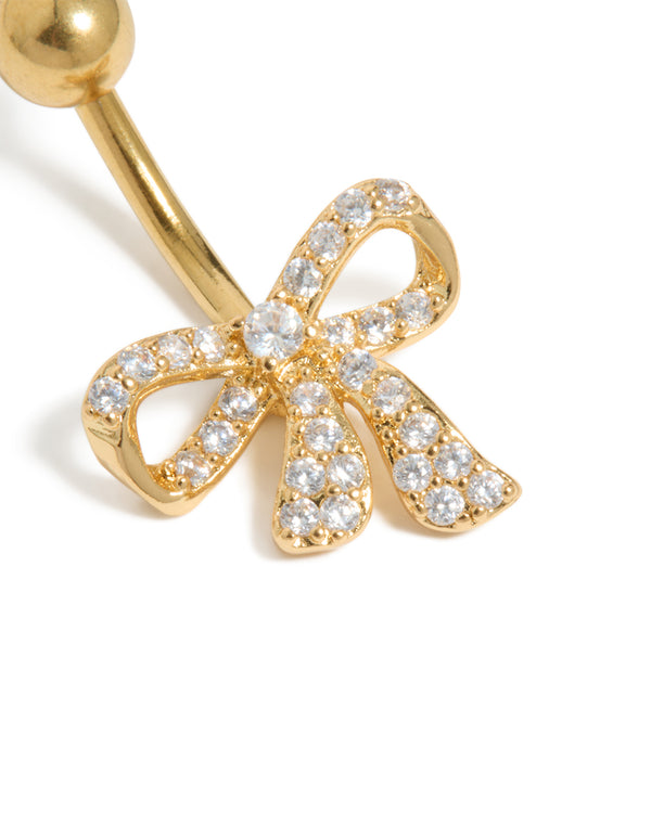 Belly bar designed with a bow in gold-plated surgical steel, featuring cubic zirconia close up view