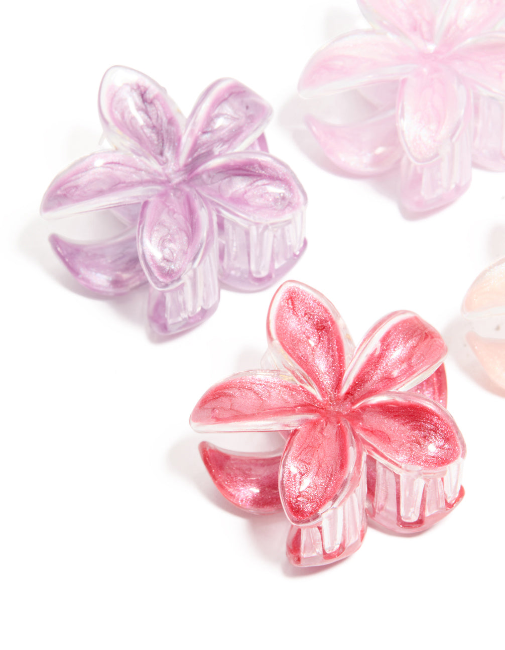 Featuring orchid light pink and peach puff frangipani floral glitter claw clips in a 4-pack with clear edges detail view