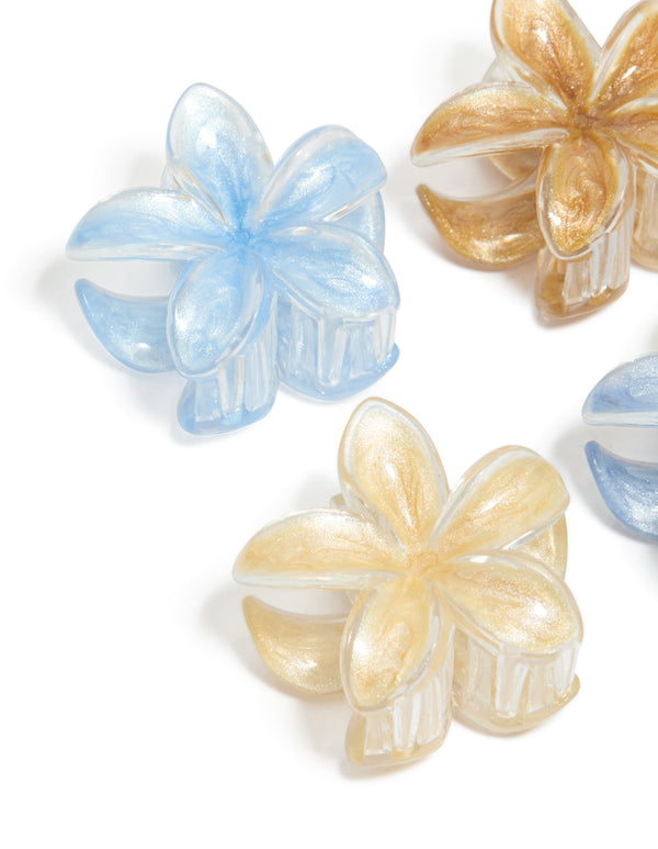 Showcasing light brown and blue clear edge frangipani claw clips in a 4-pack with floral glitter details in tan, peachpuff, and powder colors detail view