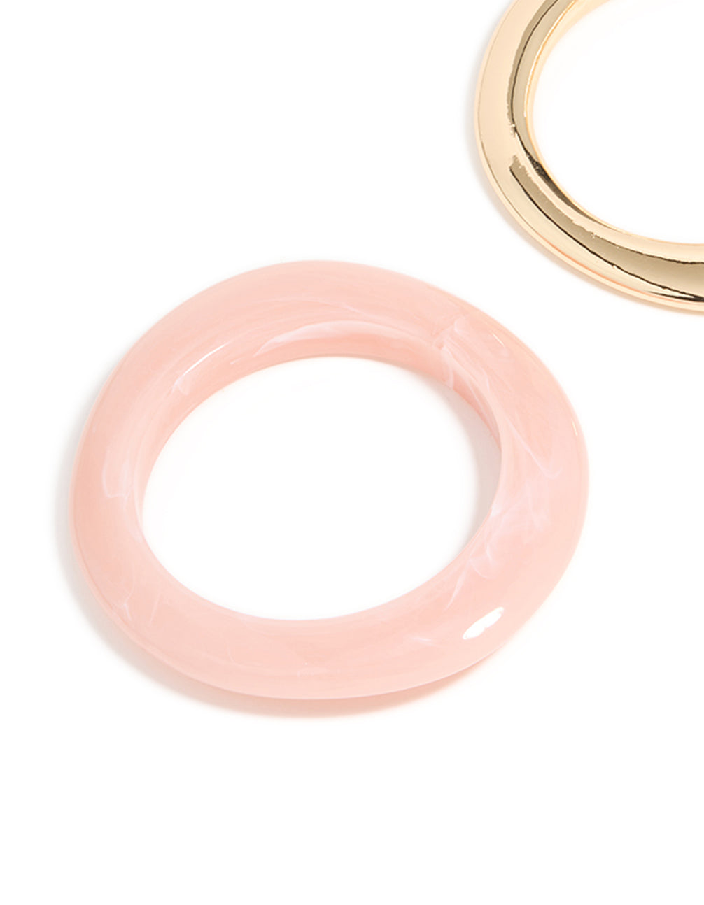 Showcasing a 2-pack of chunky acrylic bangles in gold and pink close up view