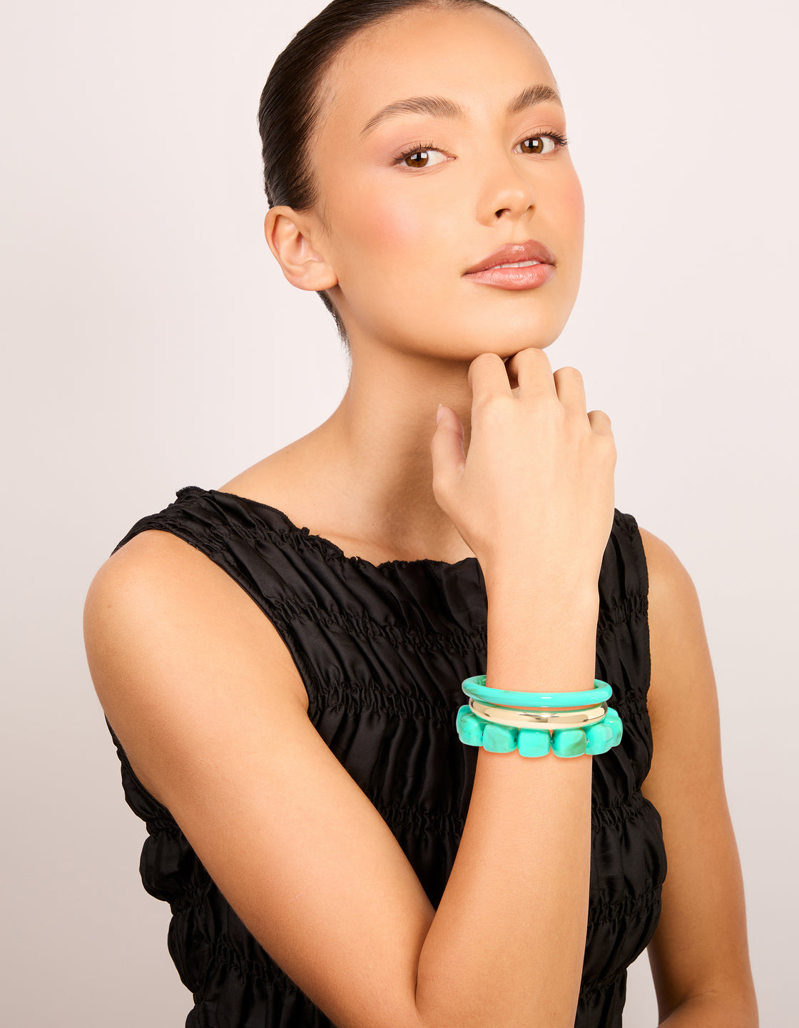 Styled gold and turquoise acrylic bracelets 3-pack with beaded bangle designs on model view