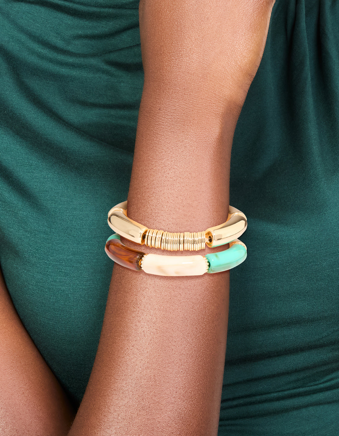 Showcasing gold with rings and acrylic stretch bracelets 2-pack featuring turquoise accents on wrist view