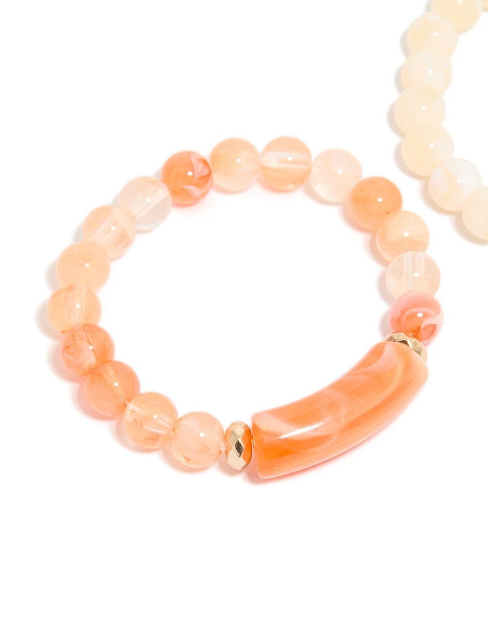 Highlighting pink and cream beaded stretch bracelets in a 2-pack with gold details in close up view