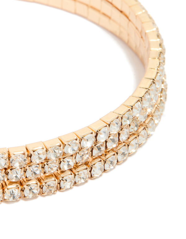 Showcasing gold diamante wrap round arm cuff featuring statement styling in close up view