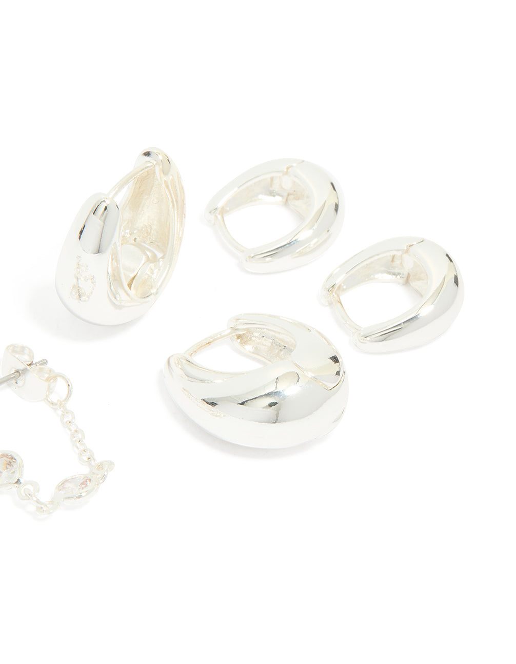 Crafted from silver plated metal these chain and huggie earrings 4-pack with huggie closures post detail view
