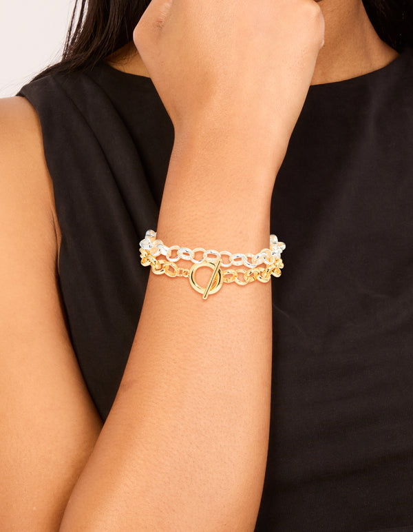Showcasing mixed metal plated round open fob chain bracelets in a 2-pack with gold and silver tones on wrist view