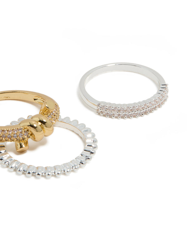 Featuring mixed metal plated cubic zirconia knotted textured rings 4-pack with beads and charm in gold, silver, clear and pink stone close up view