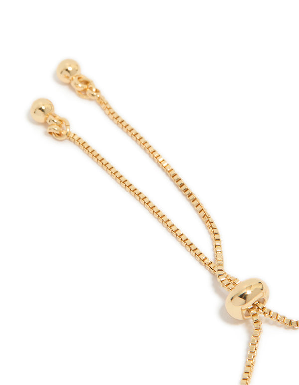 Presenting a dainty gold plated cubic zirconia mini tennis toggle bracelet closure detail view