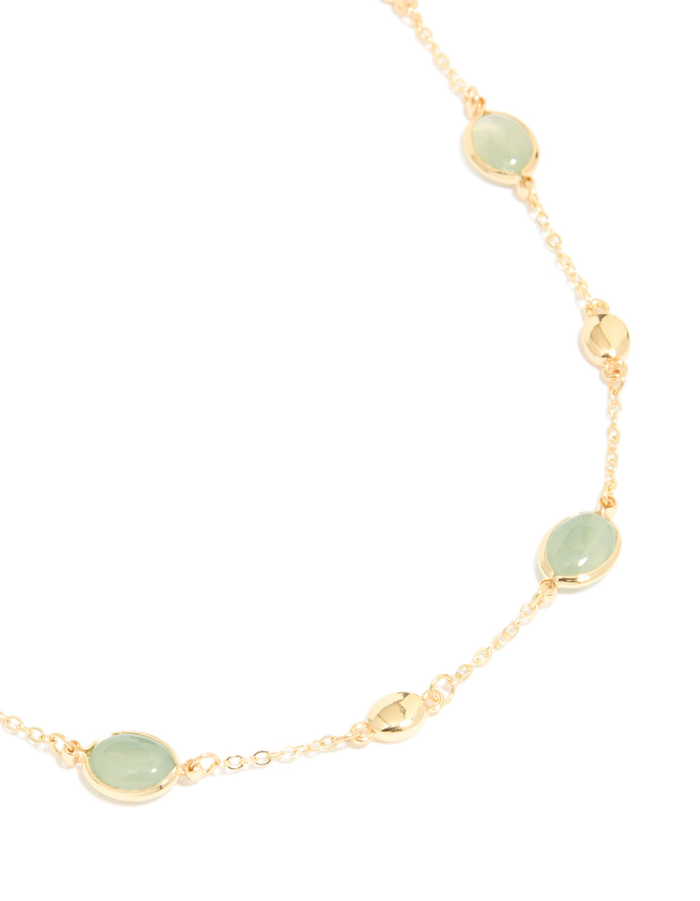 Highlighting a gold plated necklace with oval stone cut pendant in statement style close up view