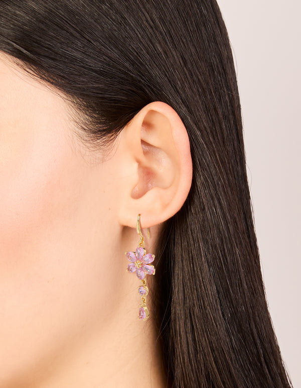 Showcasing gold pink cubic zirconia flower hook earrings, on ear view