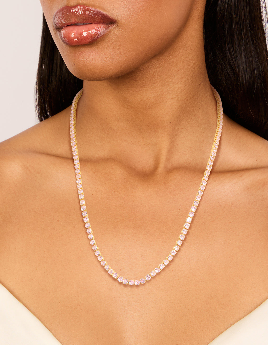 Showcasing a dainty gold cubic zirconia tennis necklace on neck view
