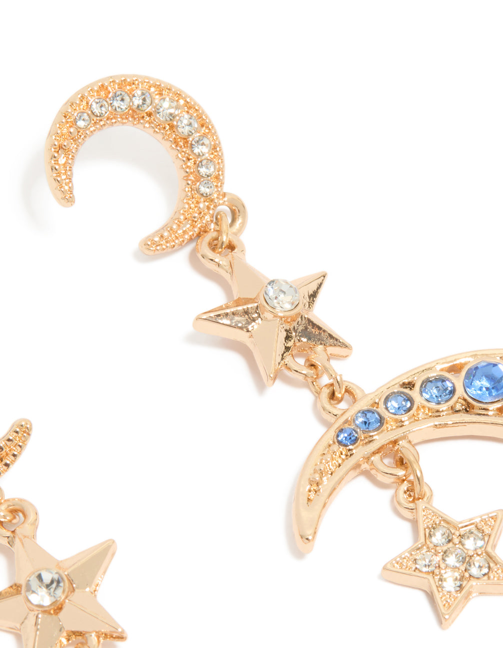 Up-close perspective of statement gold and blue diamante drop earrings featuring celestial charm with moon and star motifs post detail view