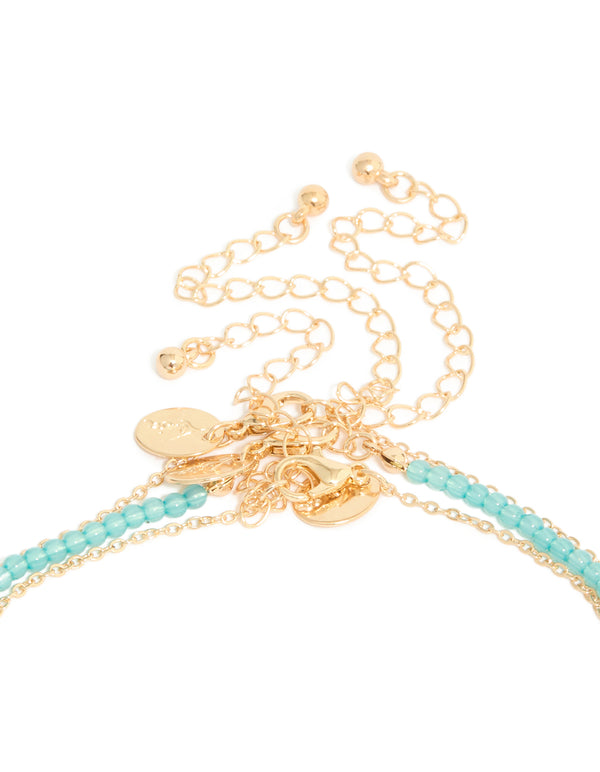 Featuring ocean-inspired shell and starfish, the gold blue beaded layered Y-necklace displays ivory accents clasp detail view