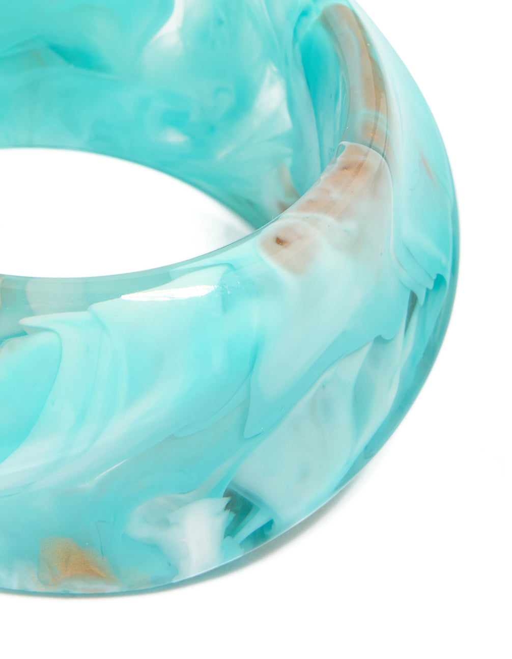 Showcasing a light turquoise and tan marbled acrylic statement bangle with chunky design close up view