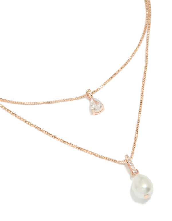 Featuring rose gold plated double layered necklace with cubic zirconia and pearl close up view