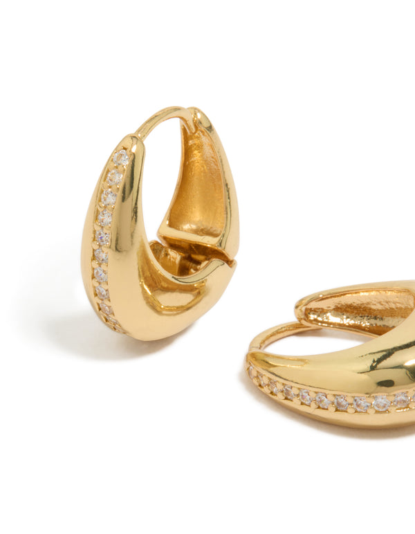 Explore teardrop huggie earrings in gold plated brass featuring cubic zirconia stones close up view