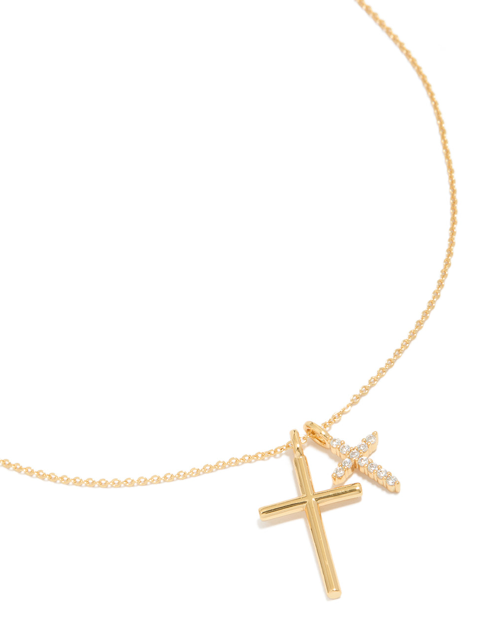 Crafted from brass, this gold plated double cross necklace features charm pendants with cubic zirconia and a dainty style in front view
