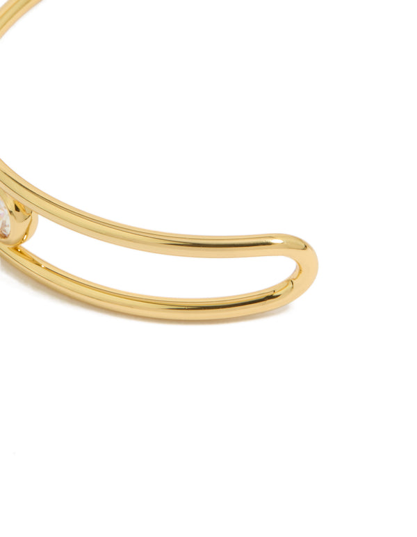 Designed with gold plated brass and bezel set cubic zirconia, this statement bangle wrist cuff highlights the closure detail view