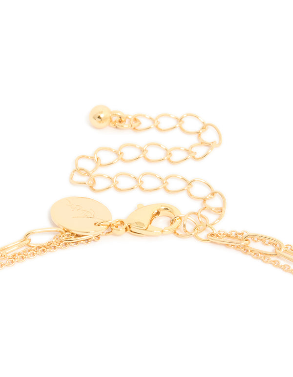 Highlighting a gold plated cubic zirconia bezel triple layered chain necklace dainty styling in clasp detail view
