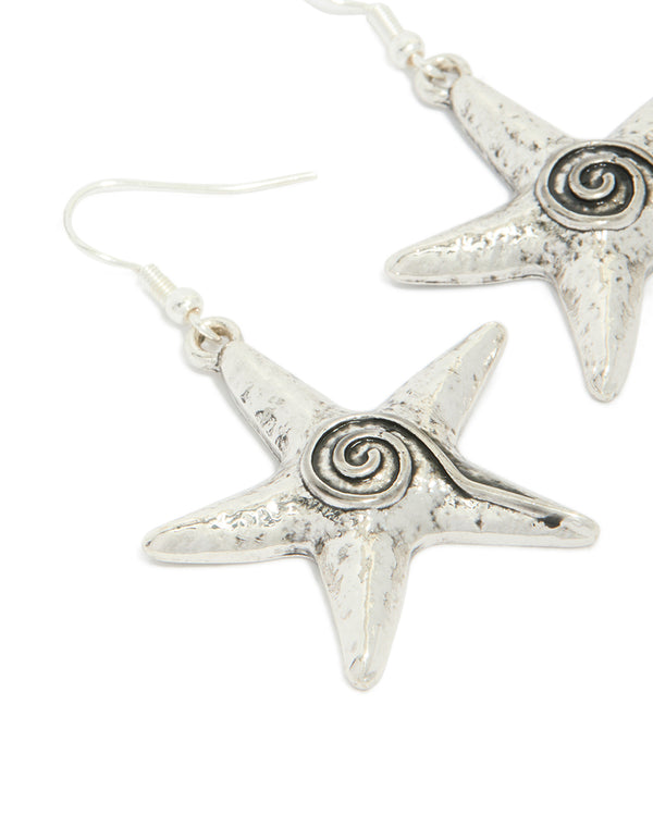 Exquisite antique silver swirl starfish hook earrings with ocean details in a close up view