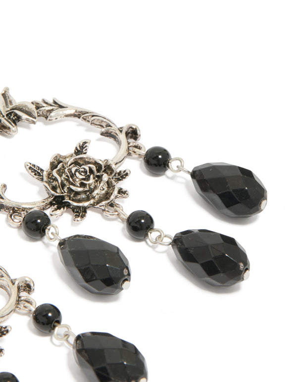 Crafted from silver with floral, beaded and charm in black, these drop earrings highlight statement style on ear view