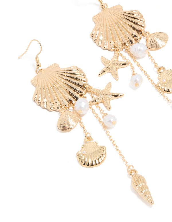 Beautifully crafted gold pearl and multi shell drop earrings with ocean-inspired charm details in white close up view